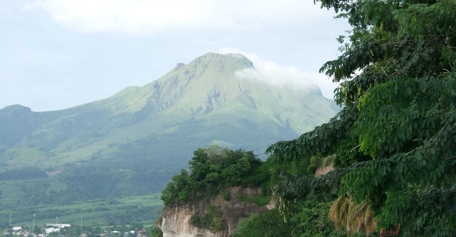 The green cone of Montagne Pelée on Martinique, its summit wrapped in cloud
