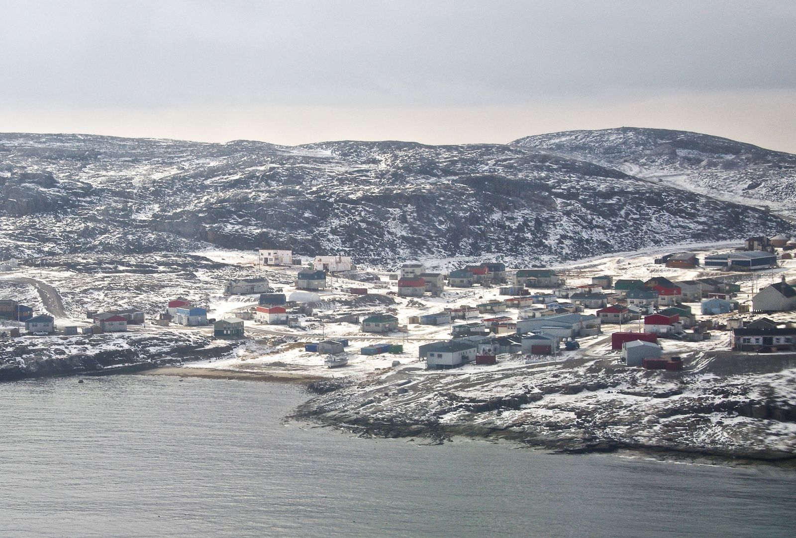 The village of Ivujivik on a snowy, rocky shore at the northern tip of Québec